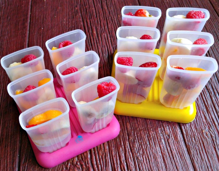 Add fruit to the popsicle molds