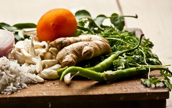 Chopping board with herbs and vegetables