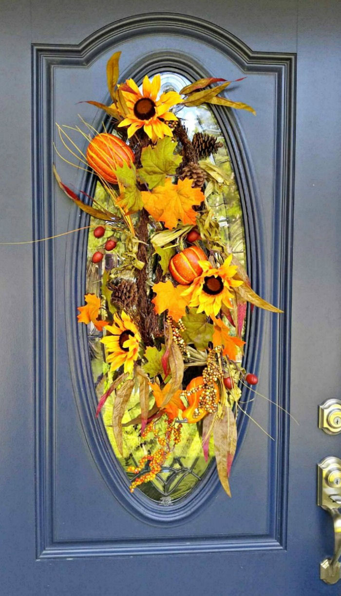 This Autumn swag on front door is the focal point of my fall entryway makeover