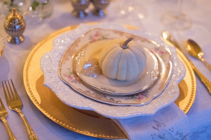 holiday table setting with small pumpkin