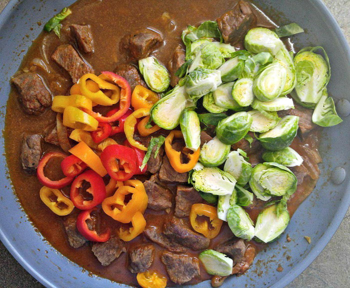 Add sweet oeppers and Brussels sprouts to the curry