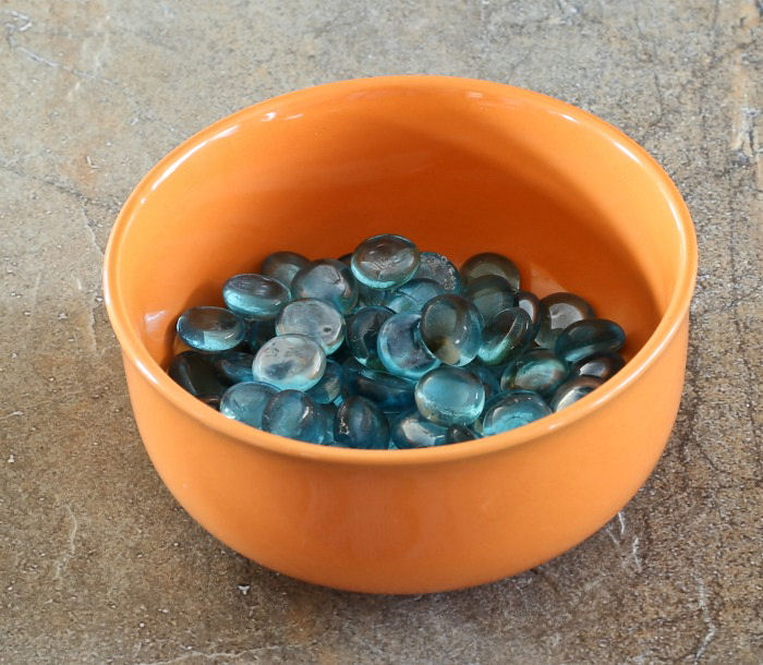 Blue rocks in an orange bowl