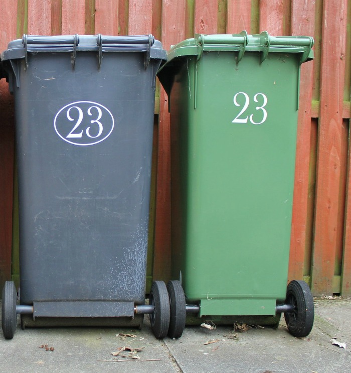 Gray and green waste bins on wheels.
