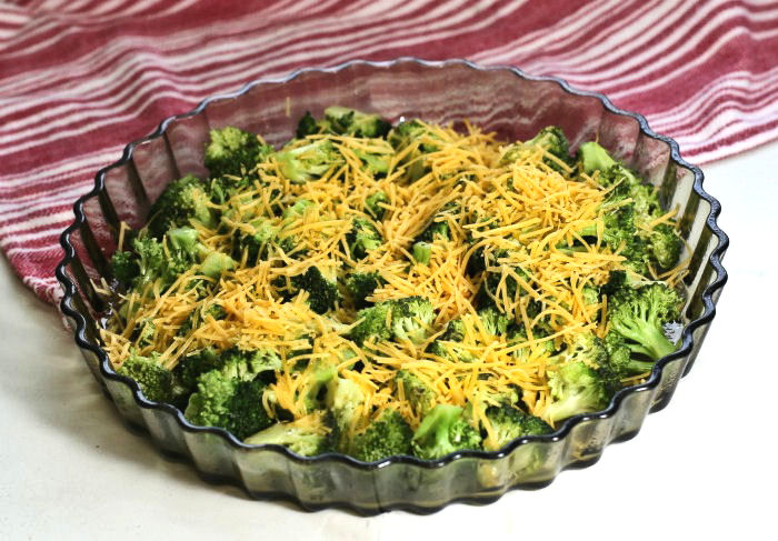 broccoli and cheese in a quiche pan