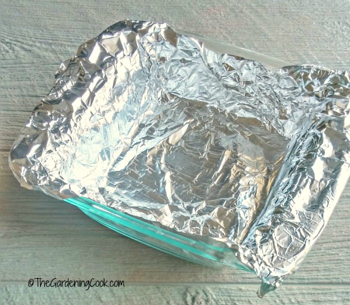 Square pan lined with foil ready to make fudge.