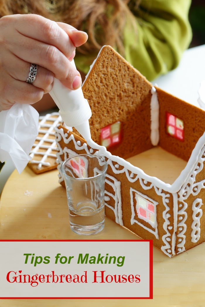 Woman adding icing to a house with text reading "tips for making gingerbread houses."