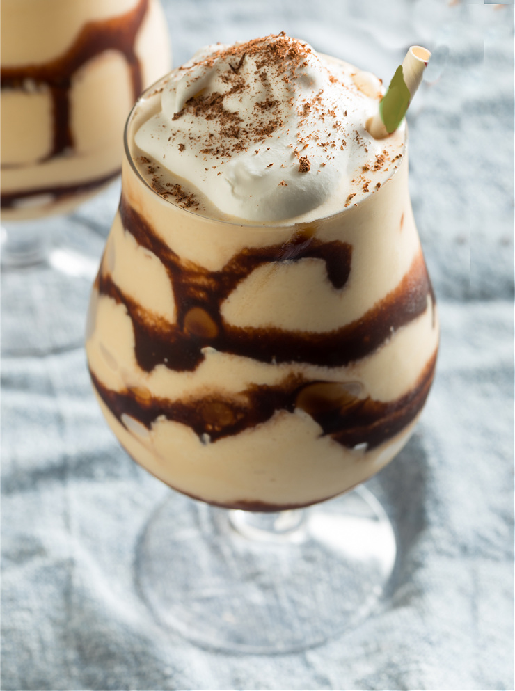 Baileys mudslide cocktail in chocolate drizzled glass with whipped cream.