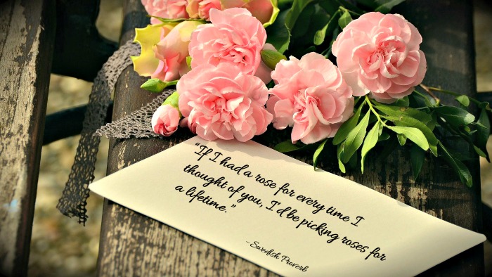 bouquet of roses on a bench with the rose quote “If I had a rose for every time I thought of you, I’d be picking roses for a lifetime.”– Swedish Proverb