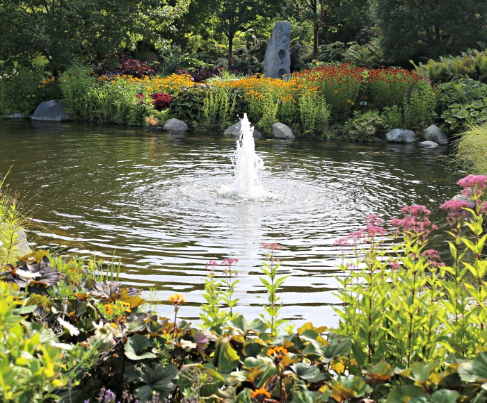 Fountain in a pond in the Garden of Five Senses at Boothbay Botanical Gardens in Maine