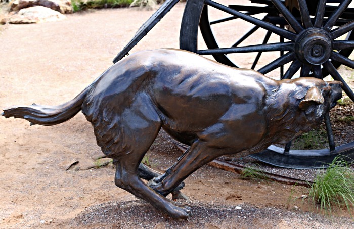 Bronze statue of a dog running
