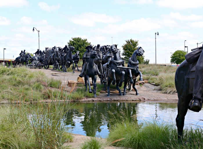 Bronze statues at the water edge of the riverwalk