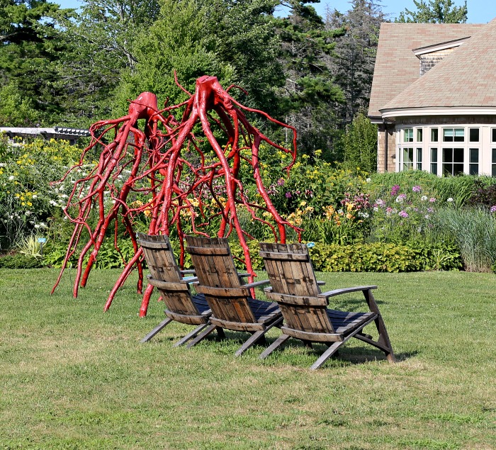 Orange metal sculptures made to look like tree roots