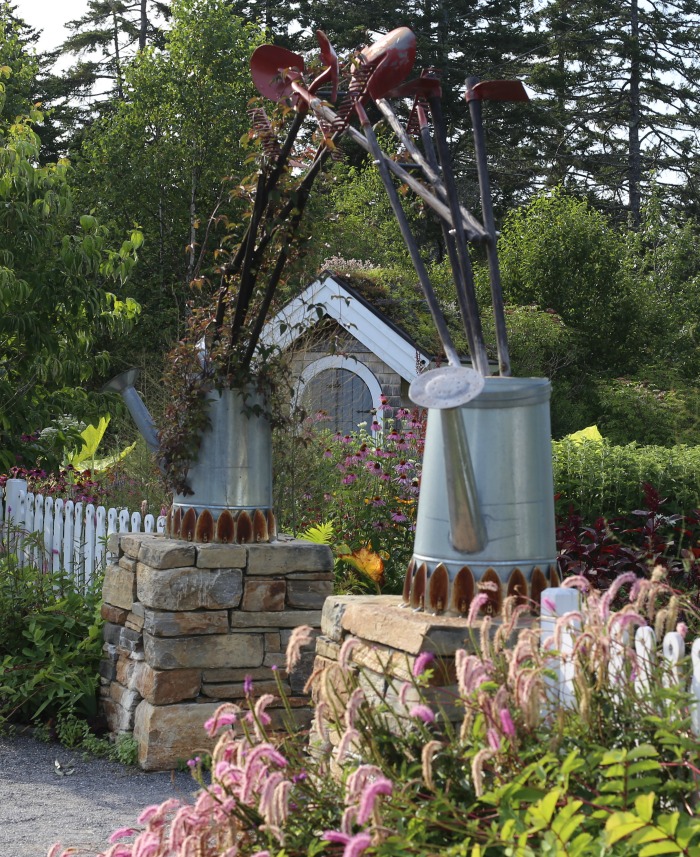 Tool arbor with watering cans, spades and shovels