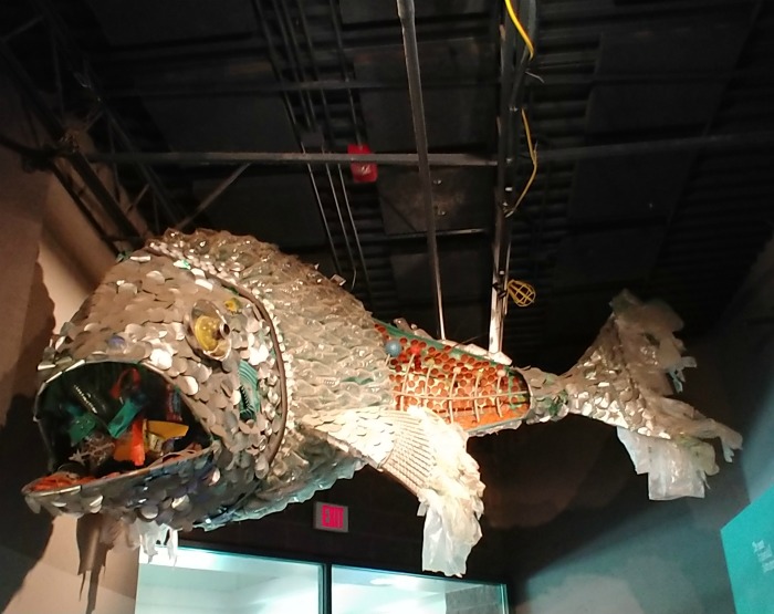 Metal fish with a mouth full of trash