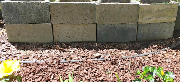 Front side of a cinder black garden bed planter
