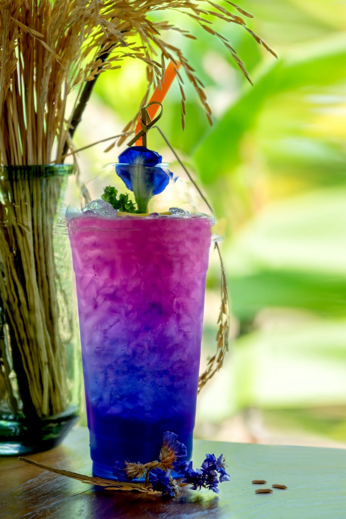 Butterfly tea flower drink changes color with shafts of wheat.