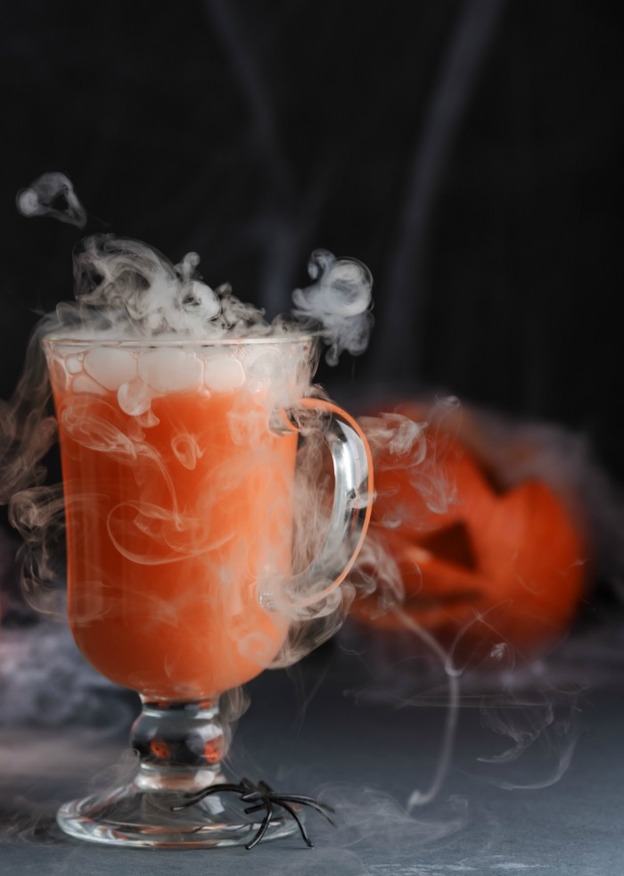 Halloween cocktail special effects - Orange Halloween drink with dry ice.