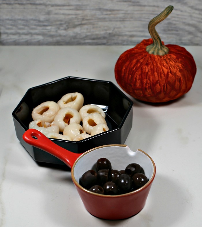 lychees, black olives and an orange pumpkin.