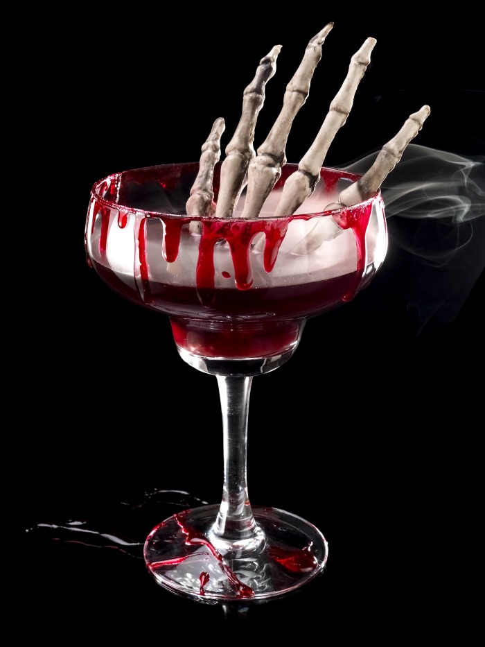 Halloween cocktail special effects - Red Halloween cocktail with a skeleton hand in it.
