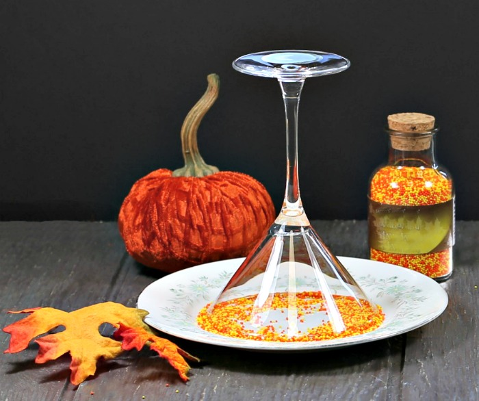 Dipping a rim of a martini glass into sprinkles.