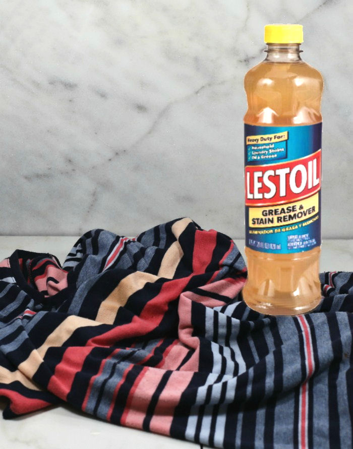 How to get vegetable oil out of clothes tip. Bottle of Lestoil on a striped shirt with cooking oil stain.