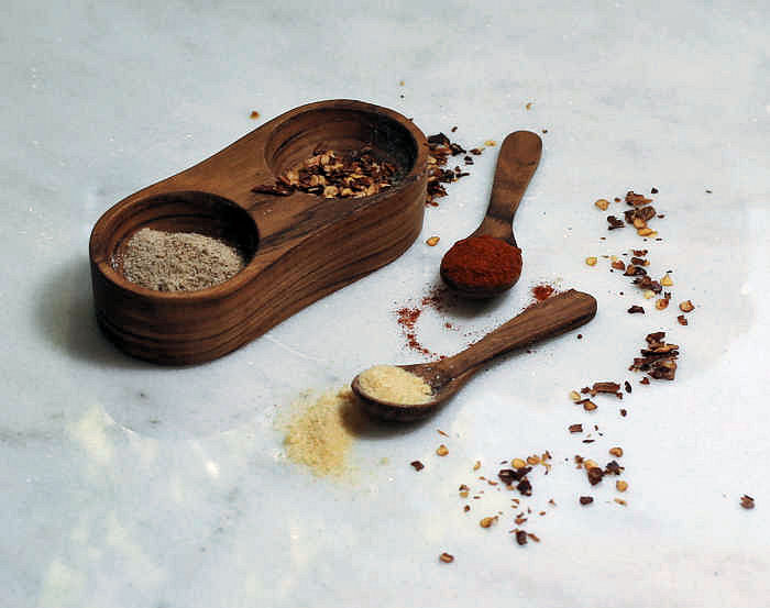 Wooden dispenser and spoons with Paprika, celery salt, red pepper flakes, onion powder
