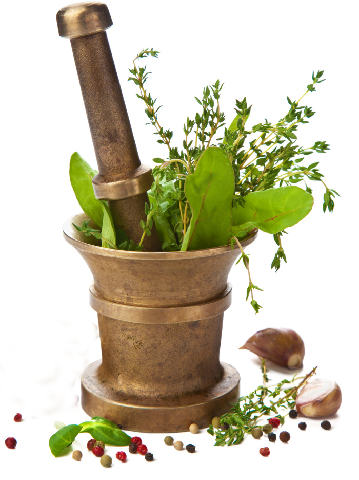 Garlic and fresh herbs with a mortar and pestle.