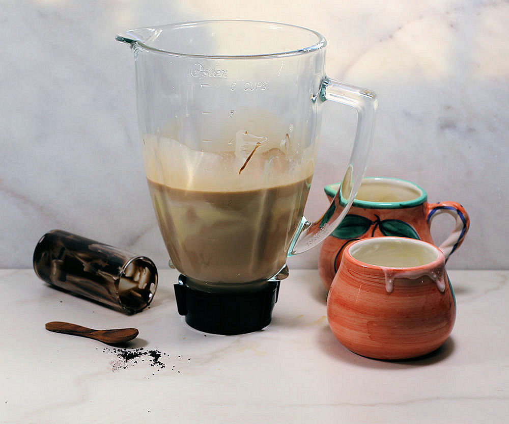 Making the recipe for Baileys Irish cream in a blender.