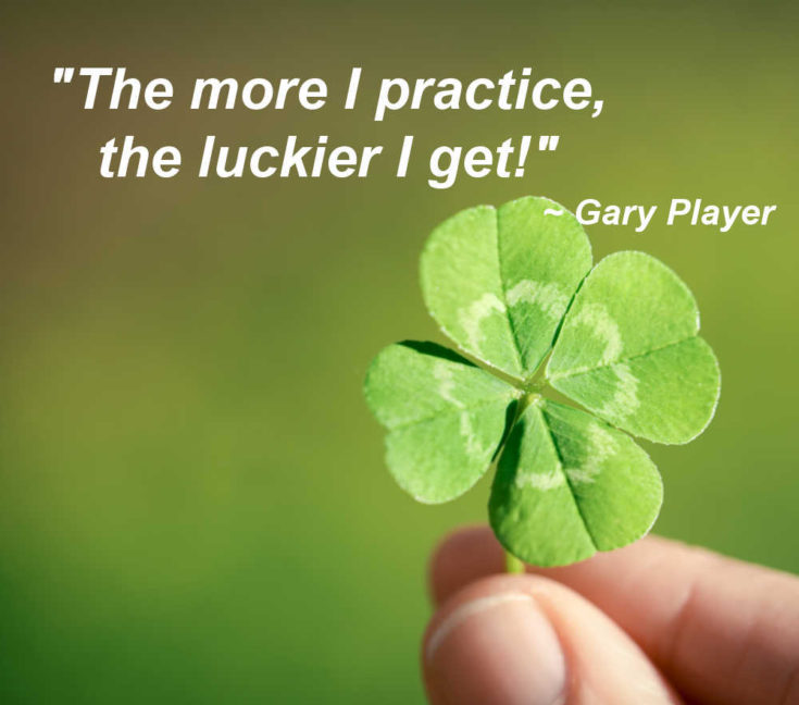 Hand holding a four leaf clover with text reading "The more I practice, the luckier I get."