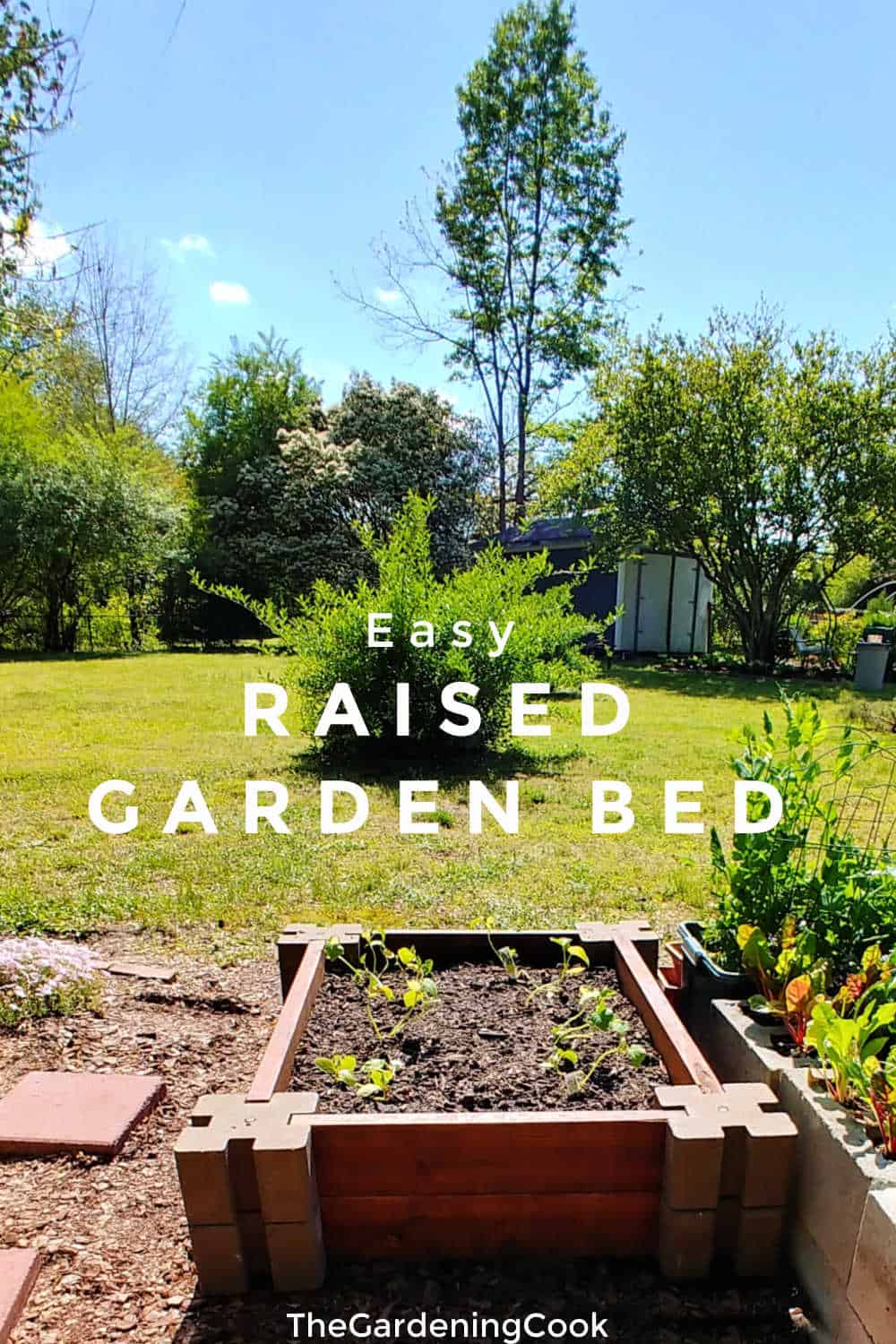 Raised garden bed near a lawn with text overlay reading easy raised garden bed.