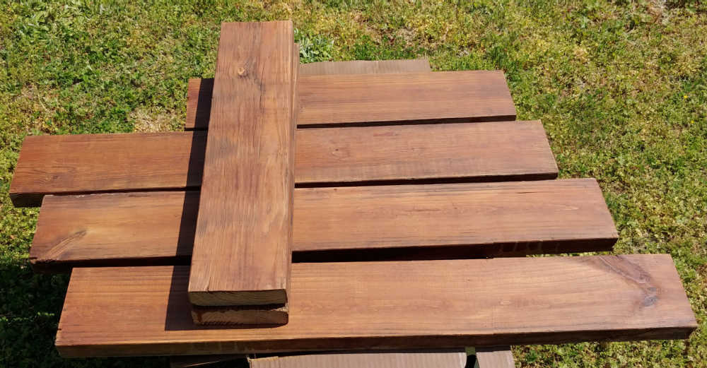 Lengths of boards stained with rustic oak wood stain.