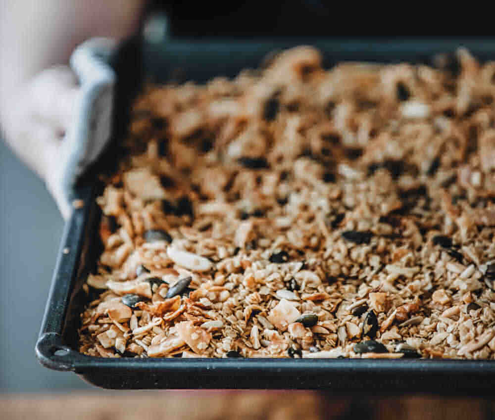 Woman holding a pan with healthy granola.