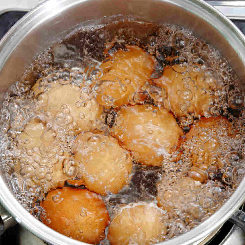 Eggs in water that is just starting to boil.
