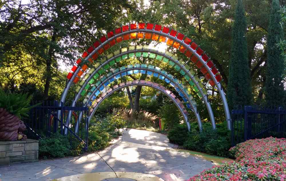 Rainbow archway made of colorful glass panes.