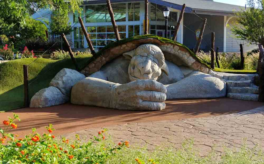 Sleeping troll under a grassy knoll.