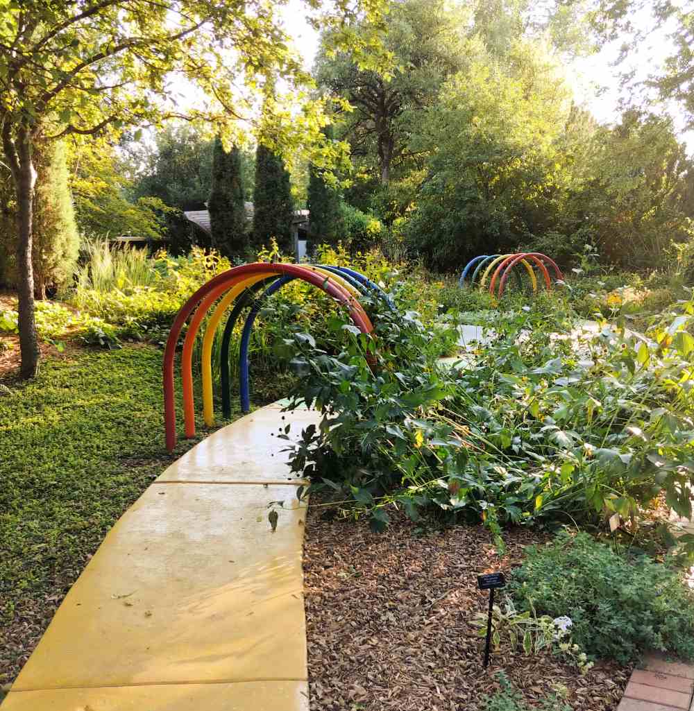 Yellow road under rainbow arches in Botanica the Wichita Gardens.