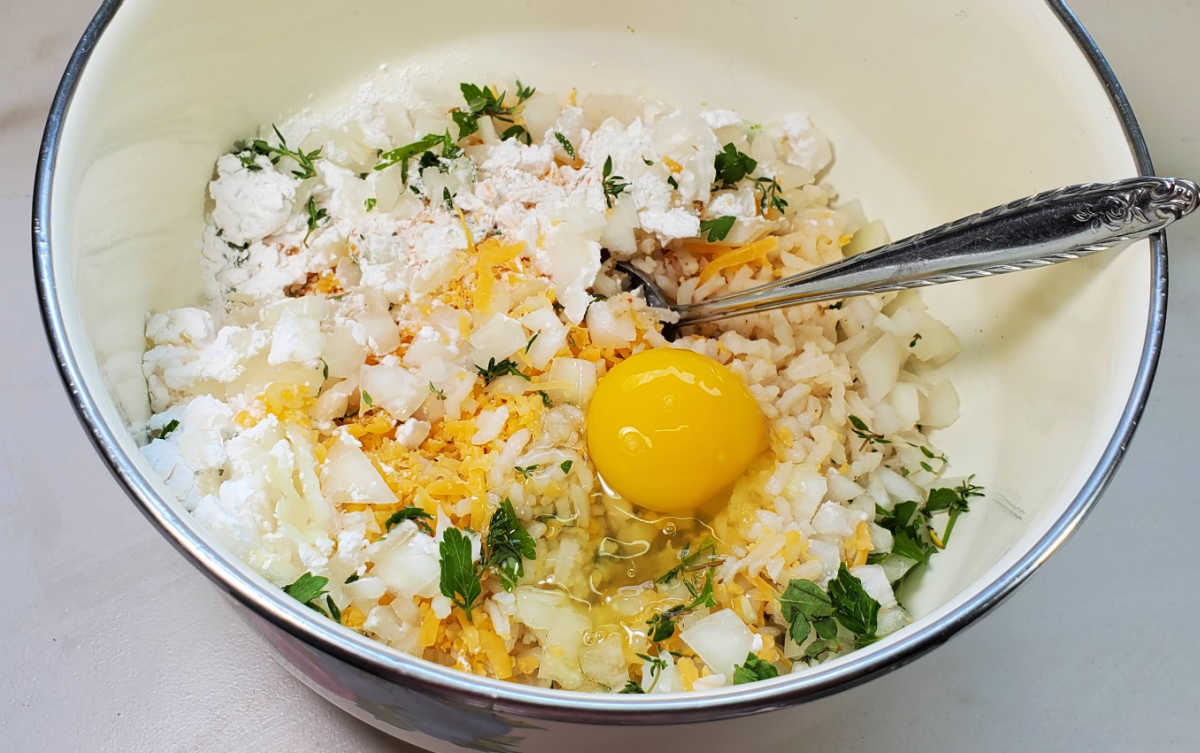 Rice, egg and herb mixture for a rice fritters recipe.